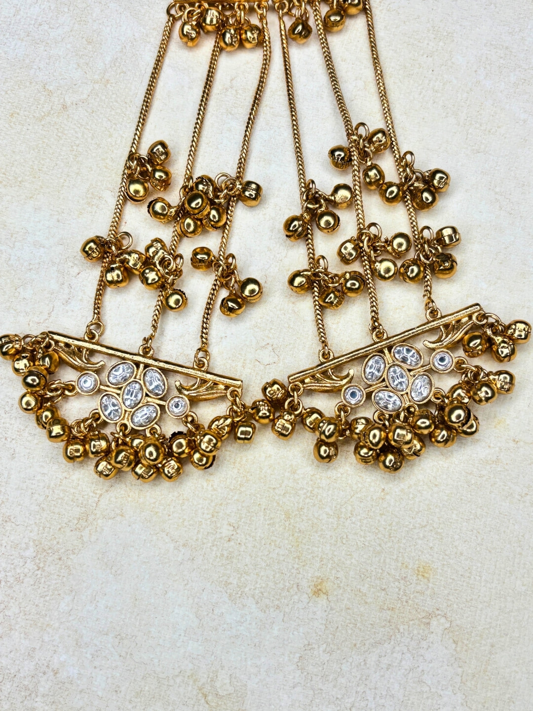 Gold-Plated White Stone Ghungroo Chain Dangler Statement Earrings